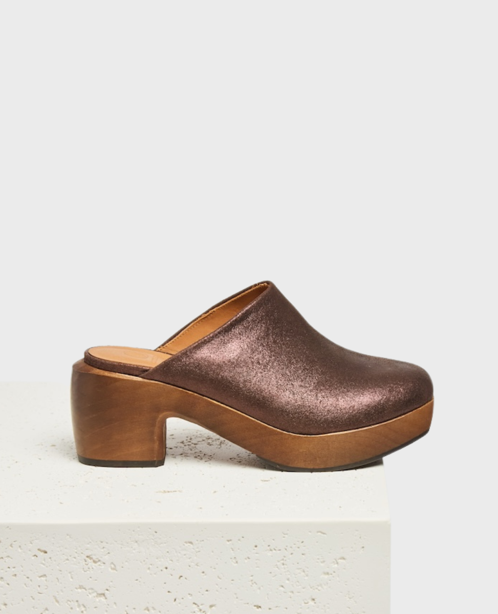 A espresso brown, metallic clog mule with a closed toe, wooden block heel, and smooth leather interior.